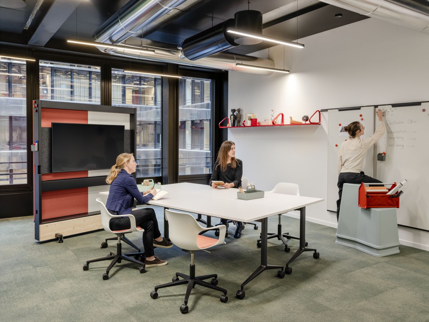 Vitra MedaMorph Klapptisch in einem modernen Büro mit drei Personen bei der Arbeit.