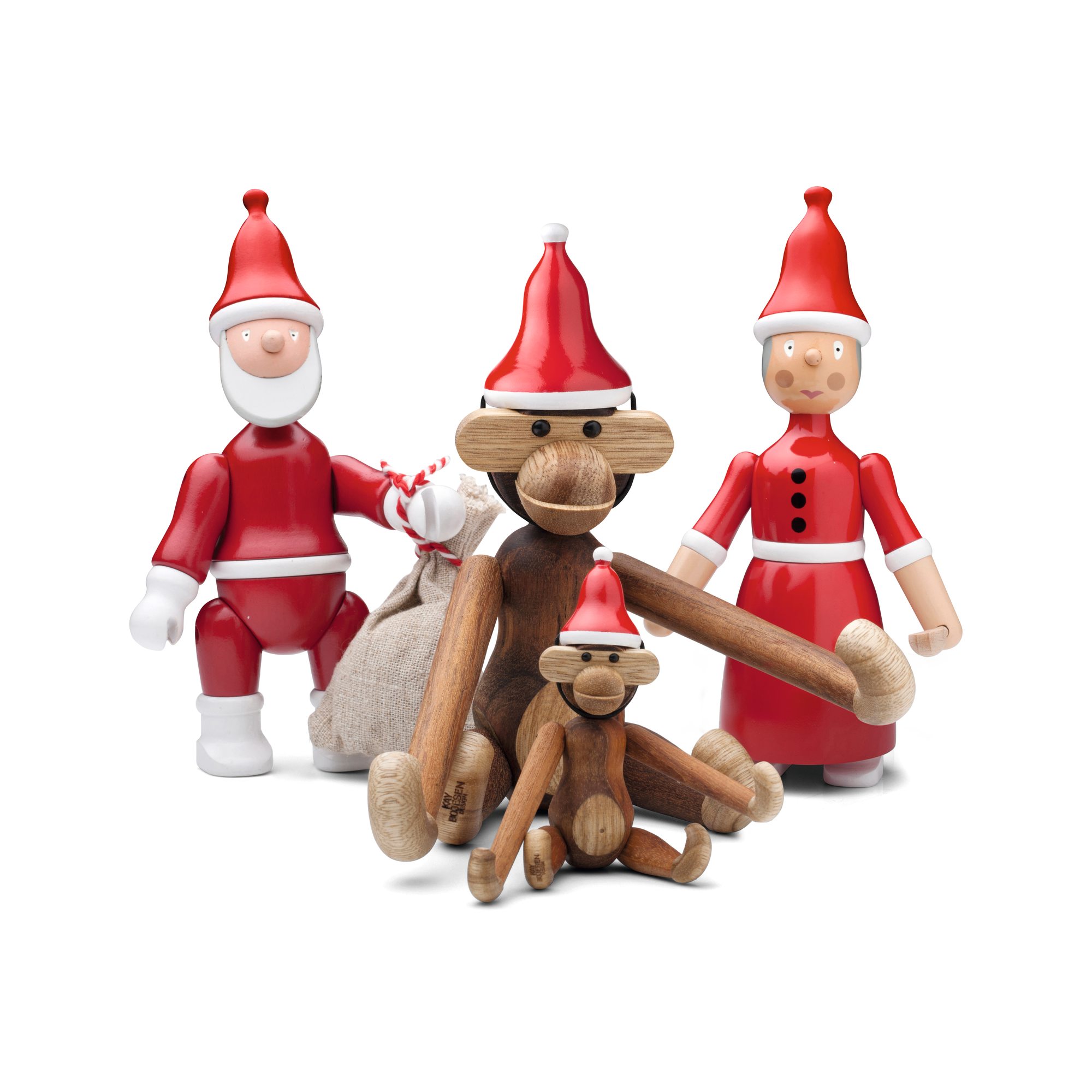 Kay Bojesen Holzfiguren Familie in weihnachtlicher Dekoration mit Nikolaus, Nikolausfrau und Affen mit roter Weihnachtsmütze.