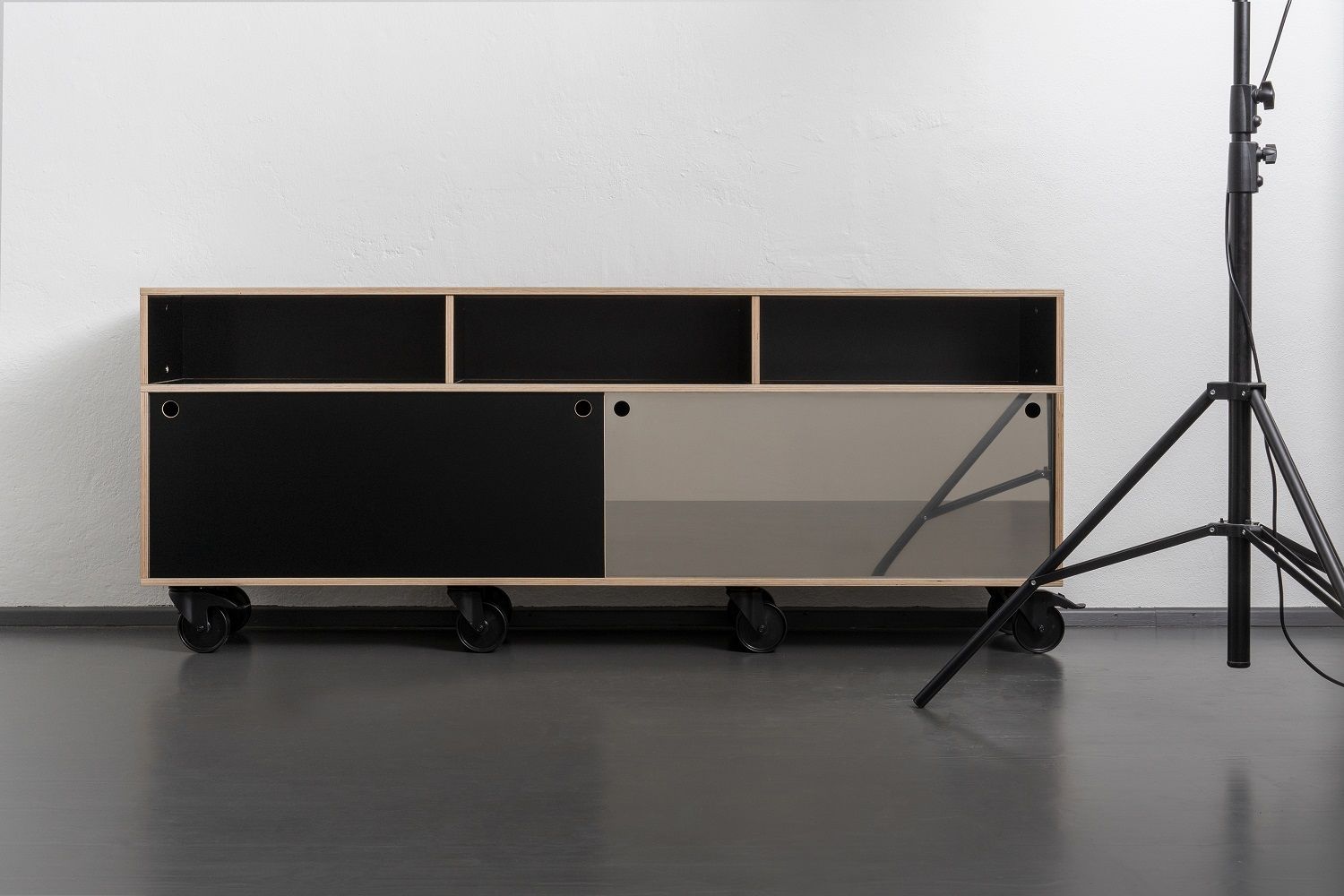 Egal Rockboard Sideboard von Nils Holger Moormann mit Rollen, schwarzen und grauen Schiebetüren.