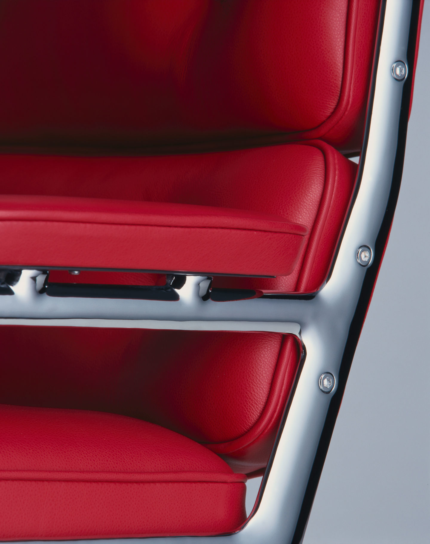 Detailaufnahme: Roter Vitra Lobby Chair ES 105 Stuhl mit verchromtem Gestell. Designklassiker für Büro und Wohnen.