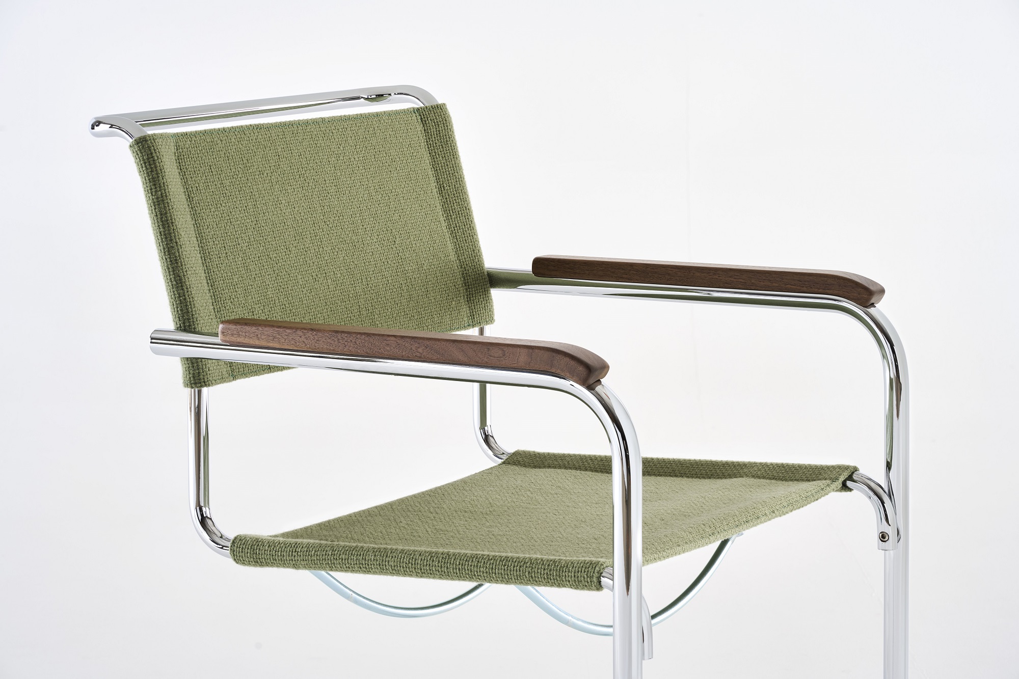 S 34 V Freischwinger von Thonet mit grünem Stoffbezug und Armlehnen aus dunklem Holz.