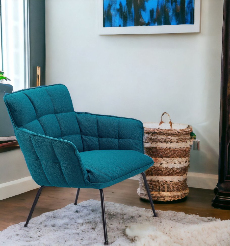 Marla Sessel von Freifrau Manufaktur, türkiser Lounge Sessel mit niedriger Sitzhöhe und schwarzen Metallbeinen.