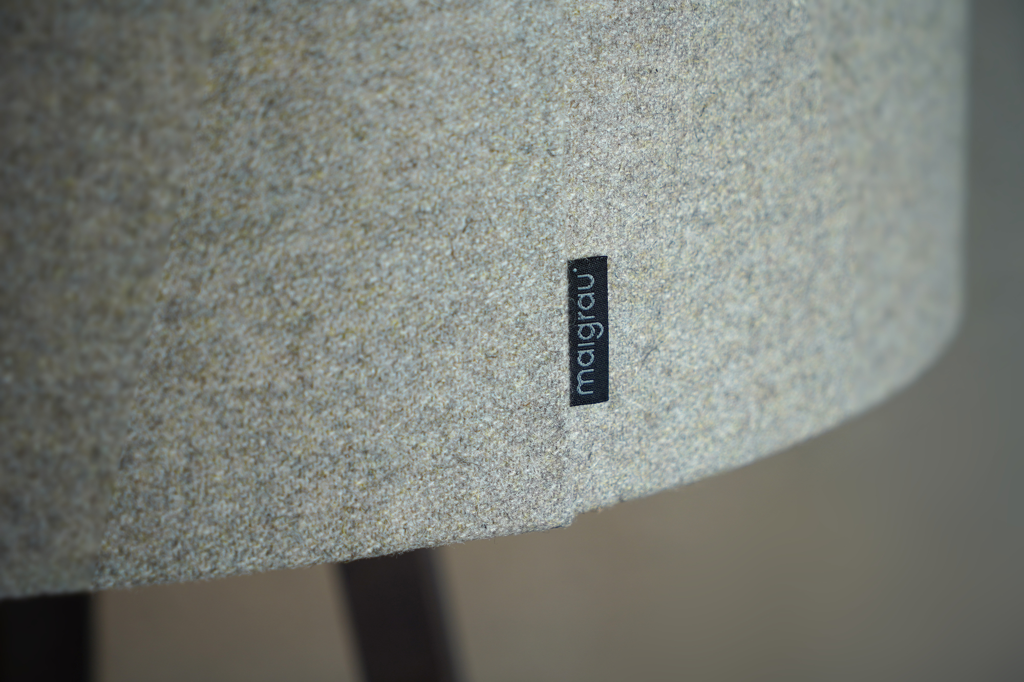 Detailaufnahme der Luca Stand Stehleuchte von Maigrau mit Stoffschirm und Markenlabel, modernes Wohnzimmerdesign.