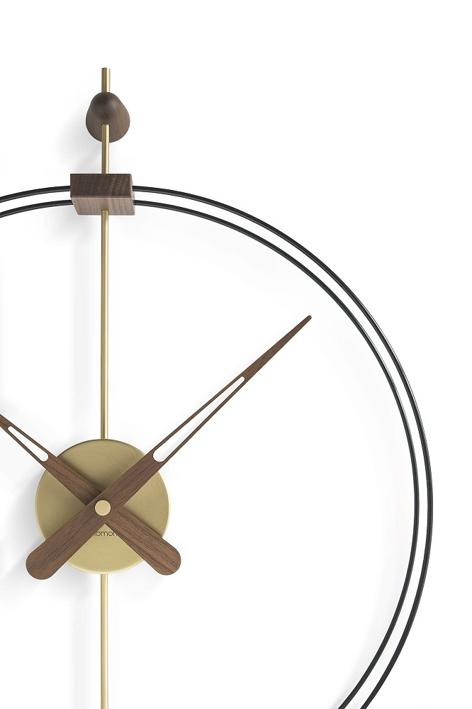 Detailaufnahme der modernen Nomon Barcelona Wanduhr mit schwarzem Rahmen, goldenen Akzenten und Holzzeigern.
