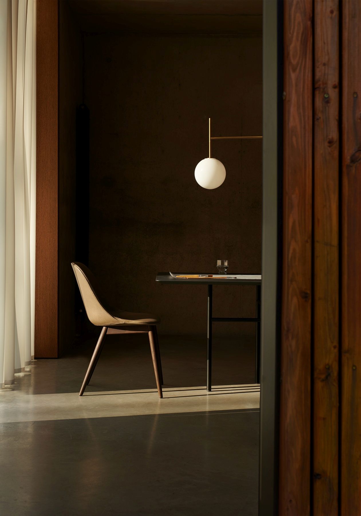 Audo Copenhagen Harbour Side Dining Chair aus Leder und Holz am Esstisch.