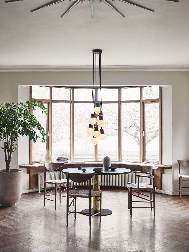 AndTradition Drawn HM3 Stuhl ohne Armlehnen aus Holz und Rattan in Esszimmer-Szene.