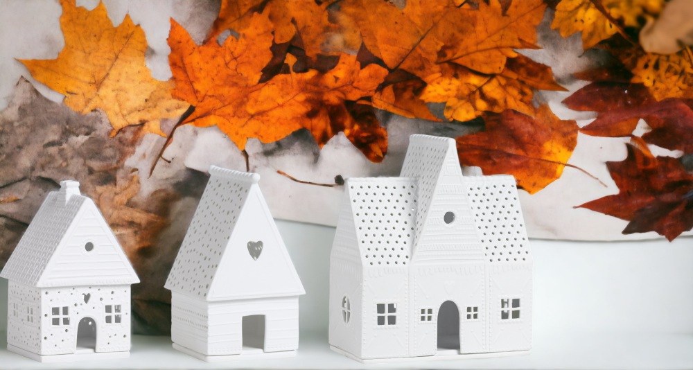 Zuhause Lichthaus 3er Set Räder, weiße Deko Häuser mit Herbstlaub im Hintergrund.