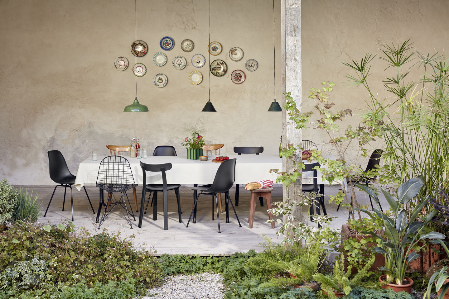 Esstisch mit verschiedenen Stühlen, darunter ein schwarzer Eames Fiberglass Chair DSX Stuhl von Vitra.