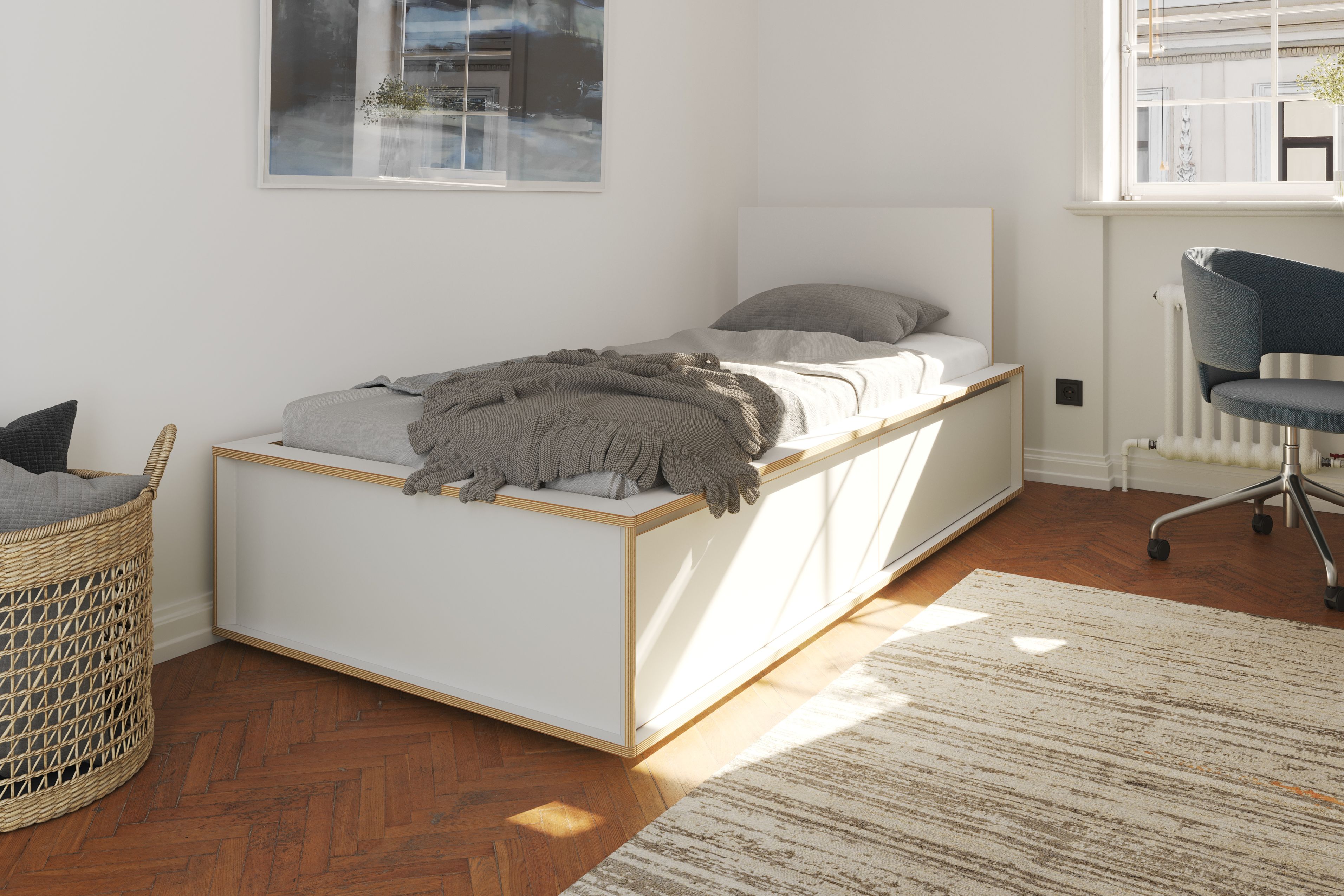 Spaze Bett von Müller Möbelwerkstätten, weißes Einzelbett mit Schubladen und grauem Überwurf im hellen Schlafzimmer.