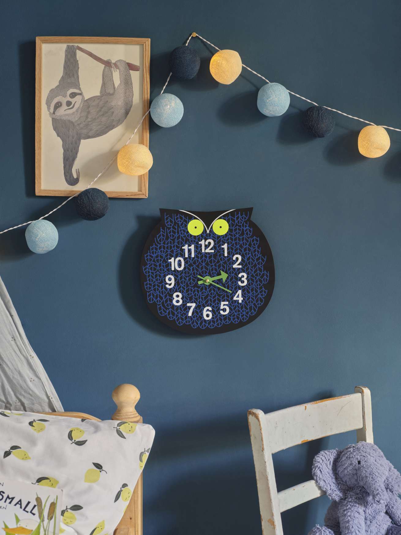 Omar the Owl Zoo Timers Wanduhr von Vitra im Kinderzimmer mit Faultierbild und Lichterkette.