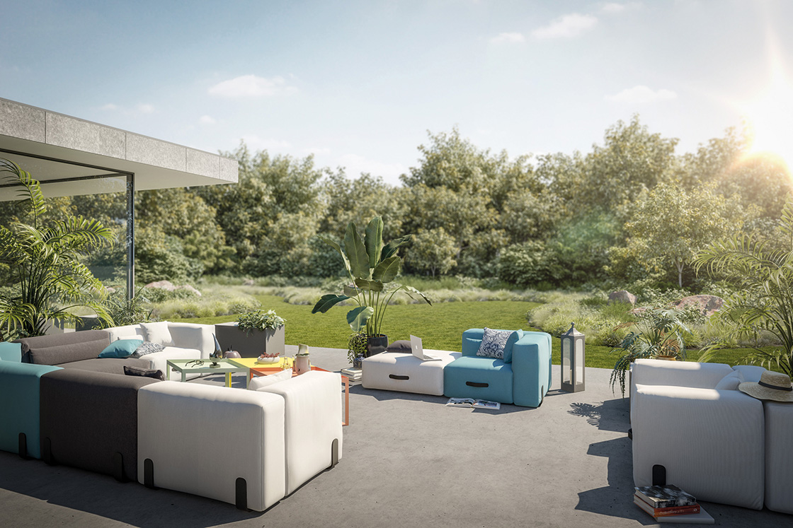 Miami Outdoor Sofa Lounger von Conmoto auf einer Terrasse mit Garten im Hintergrund.