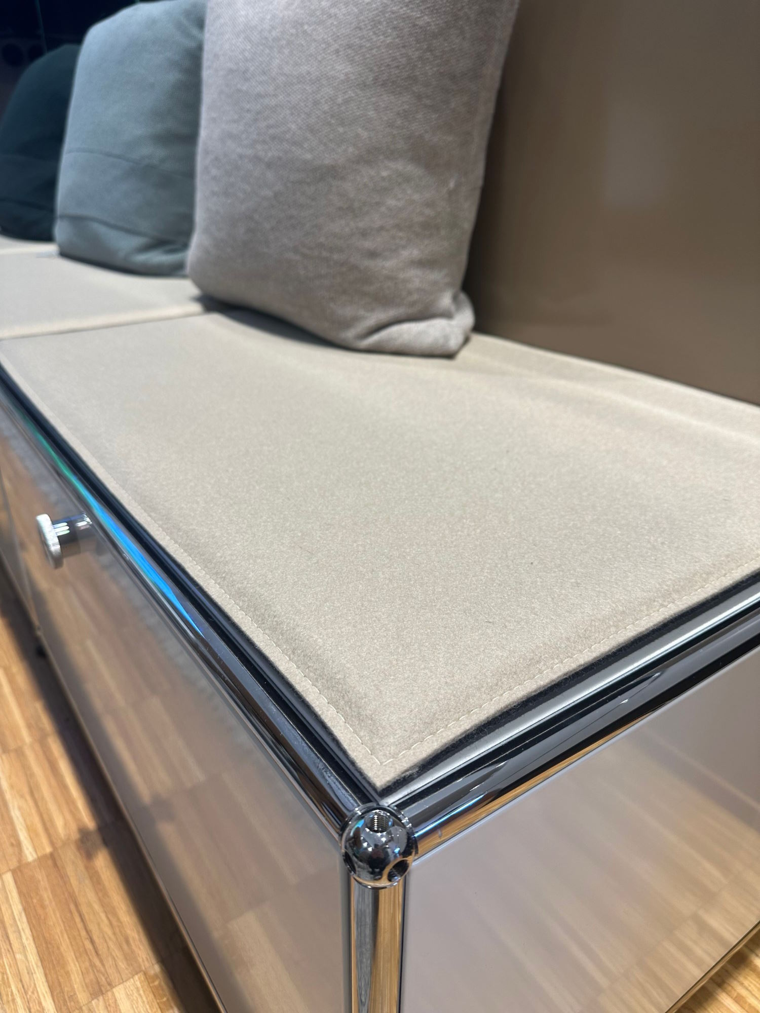 Detailaufnahme eines USM Haller Sideboards mit Sitzkissen und Kissen in verschiedenen Farben.
