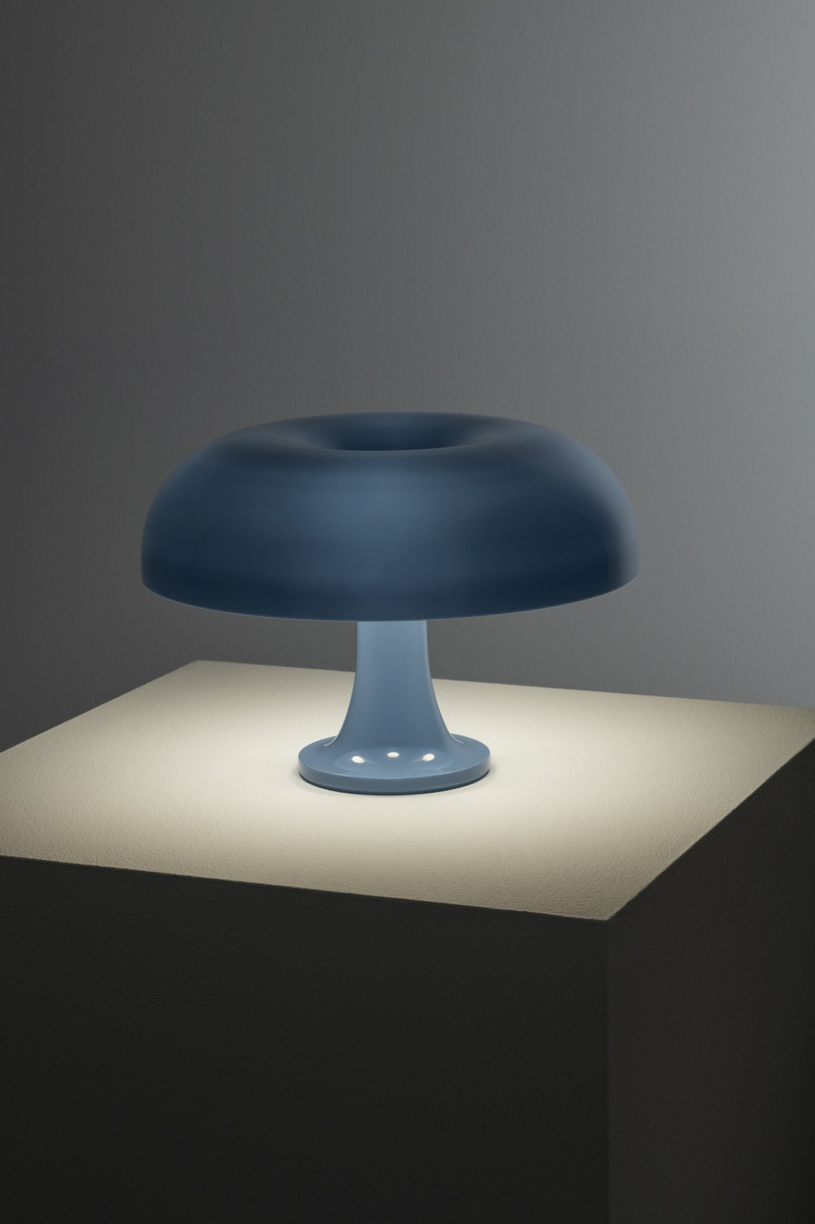 Hellblaue Nessino Tischleuchte von Artemide, ikonisches Designobjekt für stimmungsvolle Beleuchtung im Wohnraum.