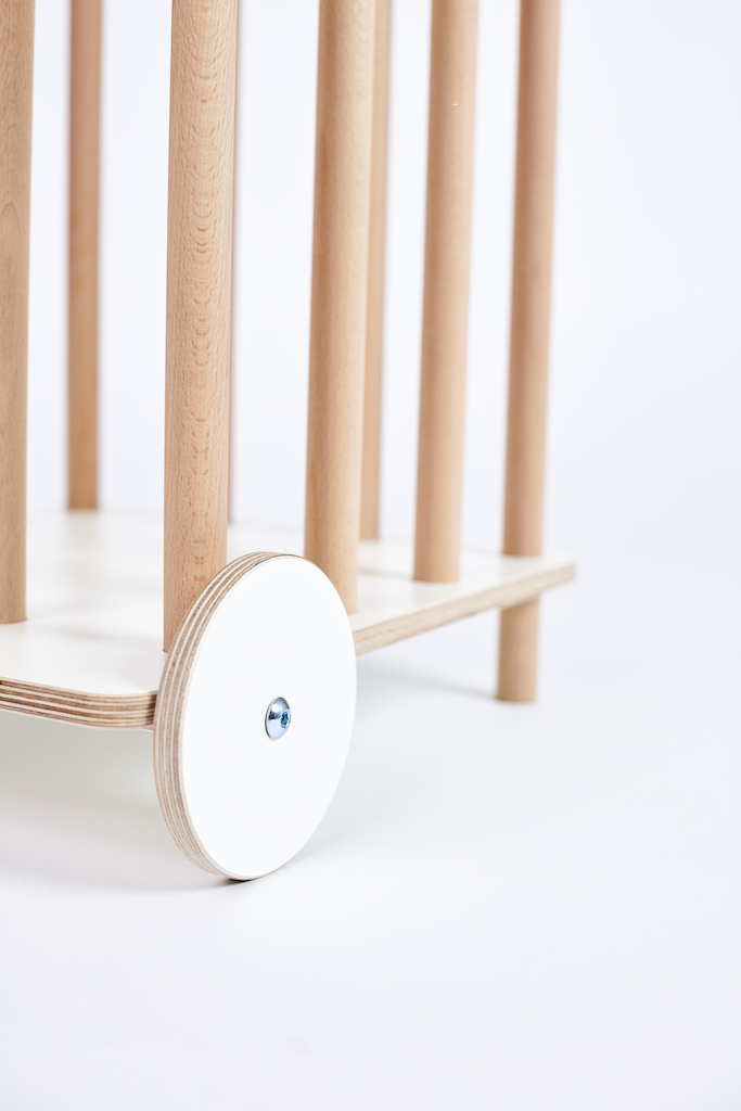 Detailaufnahme des Tojo Kids Zoo Plüschtierkarrens aus Holz mit weißen Rädern.