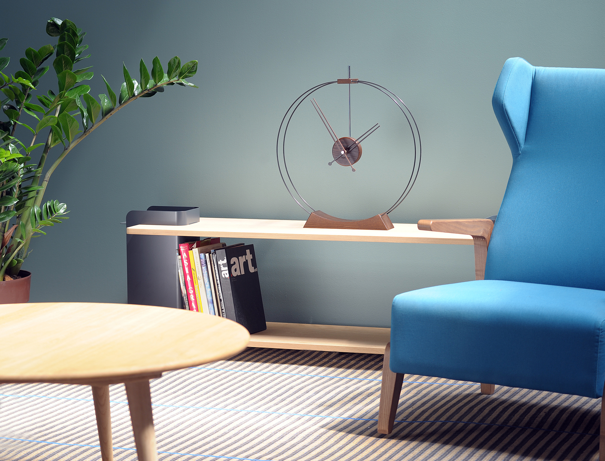 Aire Tischuhr von Nomon auf einem Regal, minimalistisches Design, moderne Dekoration für Wohnzimmer und Büro.