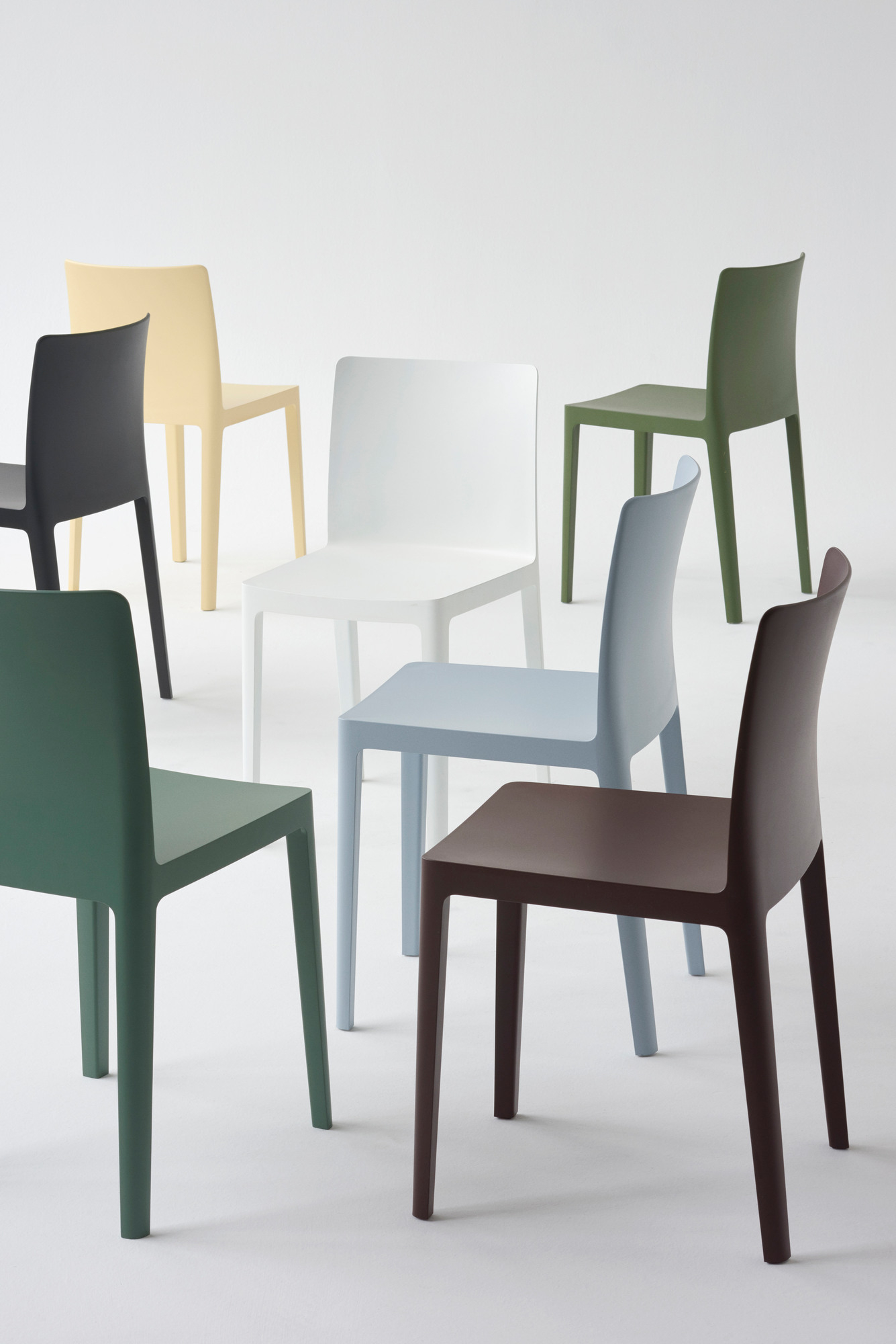 Mehrere Élémentaire Stühle von Hay in verschiedenen Farben auf weißem Hintergrund, minimalistisches Design, Outdoor geeignet.