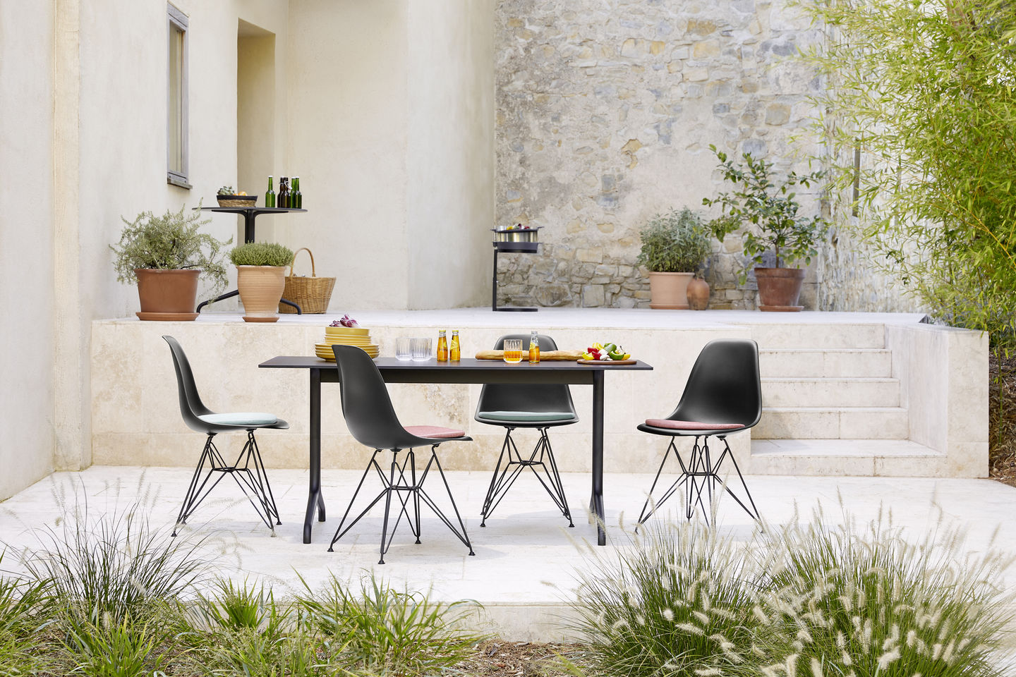 Eames Plastic Side Chair DSR Stuhl von Vitra, vollgepolstert, in schwarzer Farbe am Esstisch.