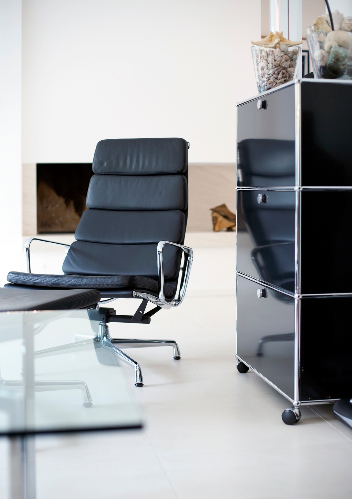 Schwarzes USM Haller Highboard mit drei Klappen im modernen Wohnzimmer, kombiniert mit Designermöbeln.