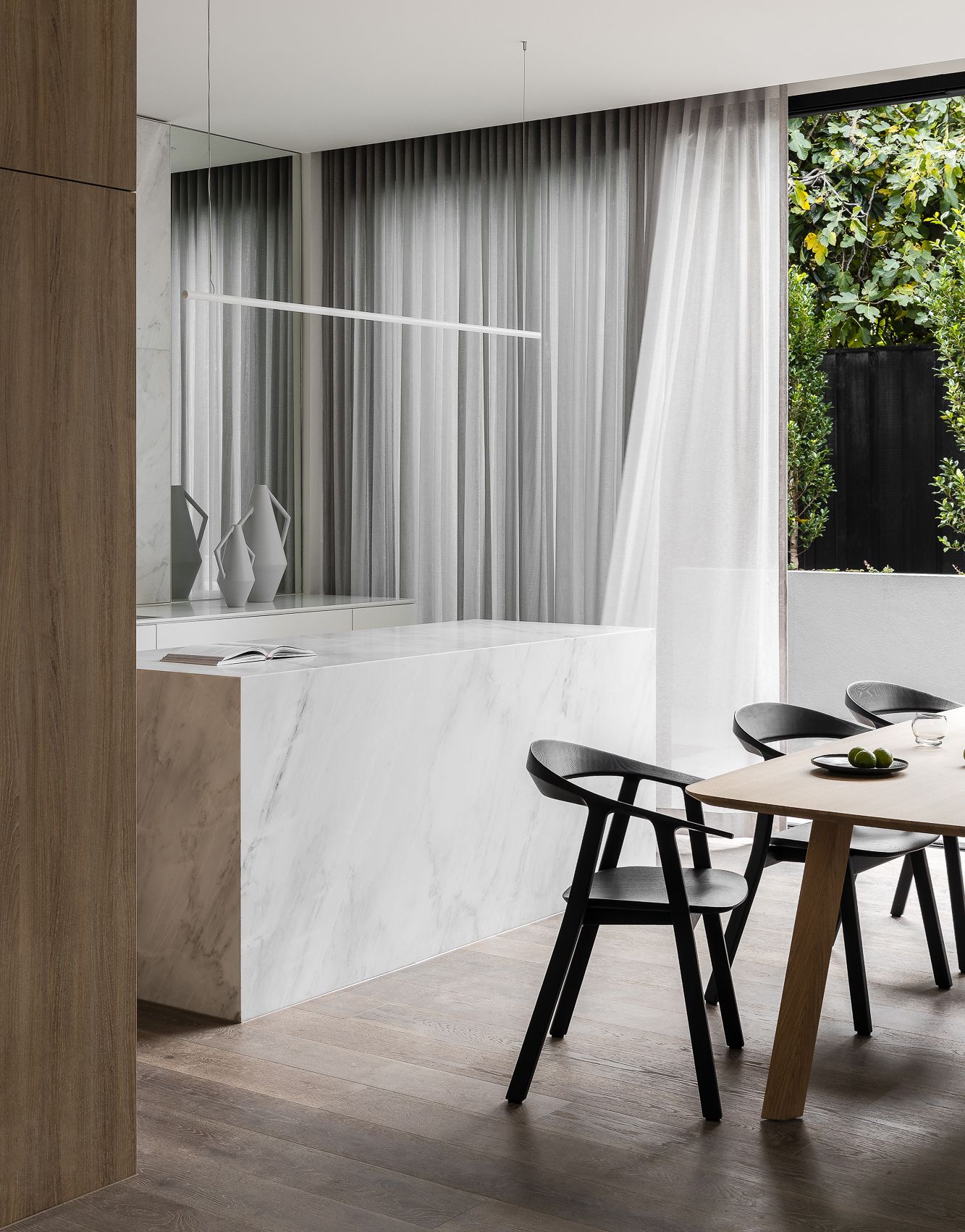 Esszimmer mit Holztisch und schwarzen Rhomb Stühlen von Prostoria, minimalistisches Design.