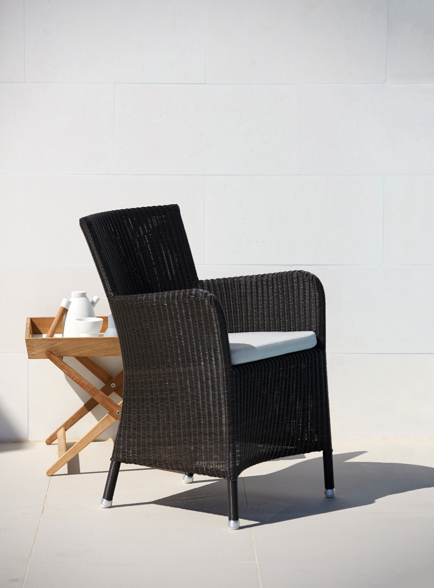 Hampsted Cane-Line Sessel aus Rattan in Schwarz mit Sitzkissen für den Garten.