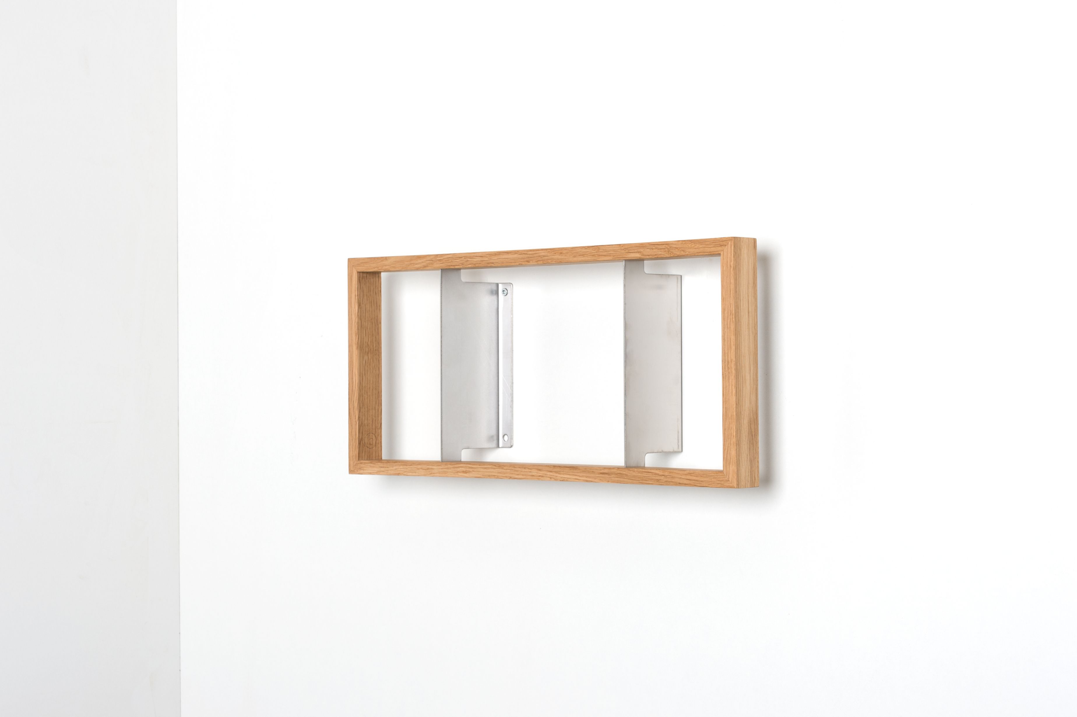 Wandregal aus Eiche, Modell b, EINZELSTÜCK, mit Metallhalterungen an einer weißen Wand.