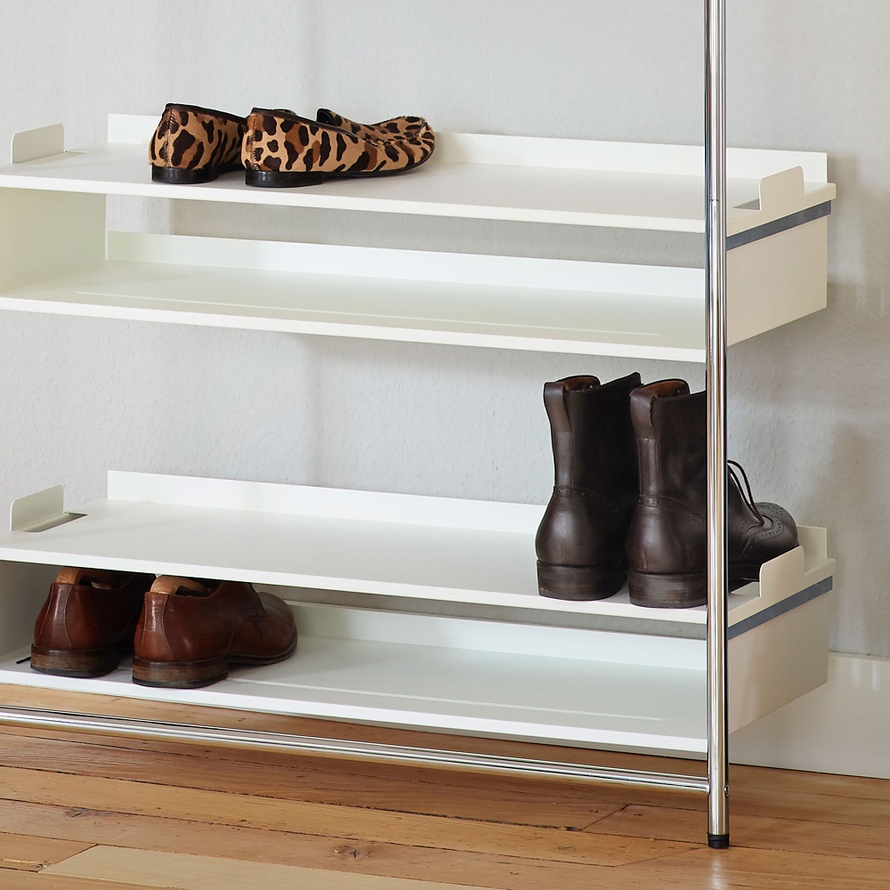 Comba Anlehngarderobe von Mox mit weißen Regalböden und verschiedenen Schuhen auf einem Holzboden.