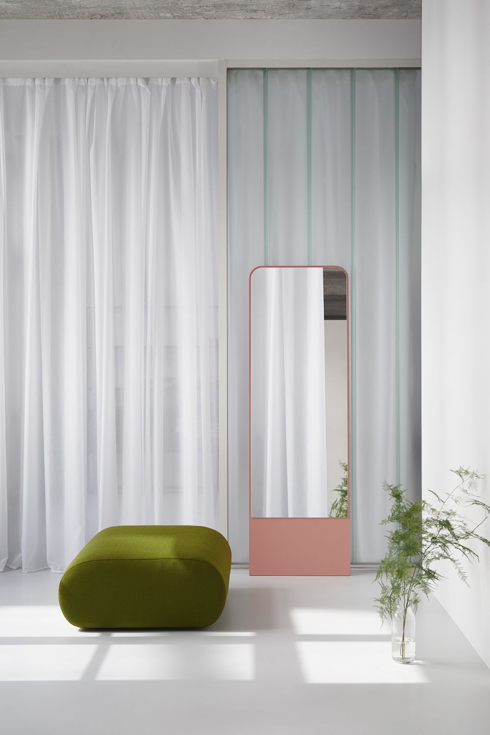 Moderner Standspiegel FRIEDRICH Esche OUT mit rosafarbenem Rahmen und grüner Sitzbank im minimalistischen Interieur.
