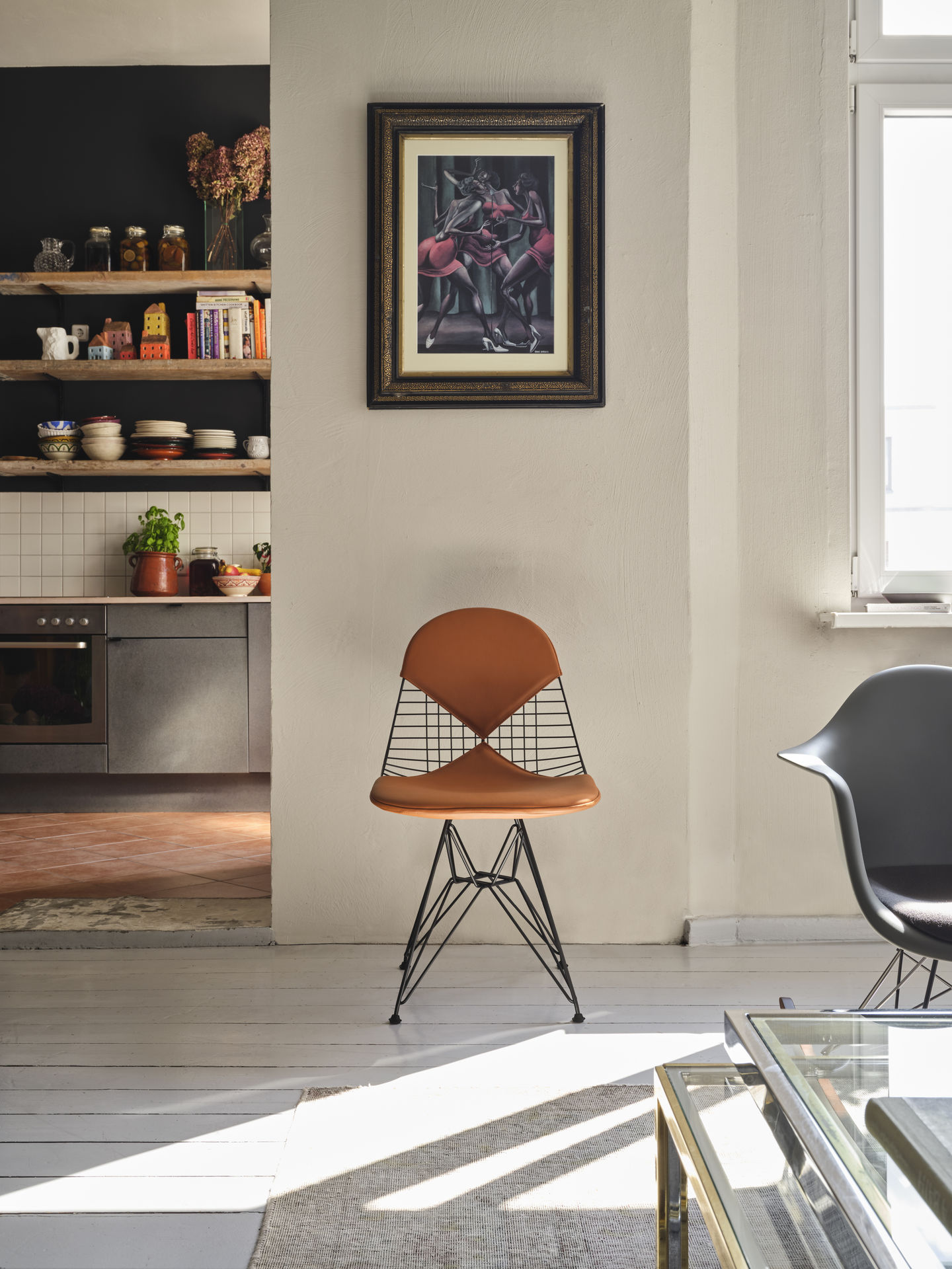 Vitra DKR-2 Wire Chair Stuhl mit braunem Sitzpolster und schwarzem Drahtgestell in modernem Wohnraum.
