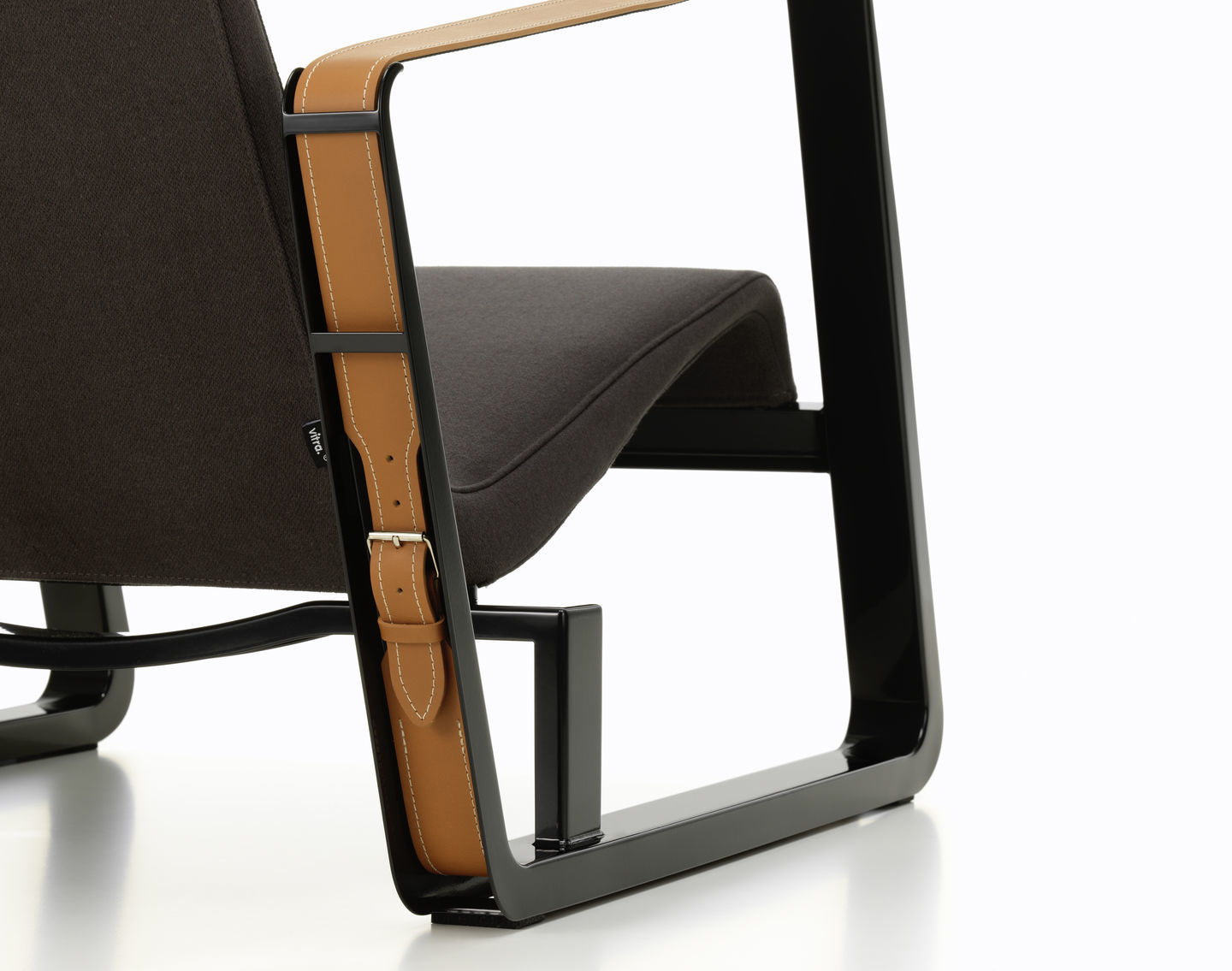 Detailansicht des Vitra Cité Sessels mit braunem Stoffbezug und Lederarmlehnen, modernes Möbeldesign für Wohnzimmer und Büro.