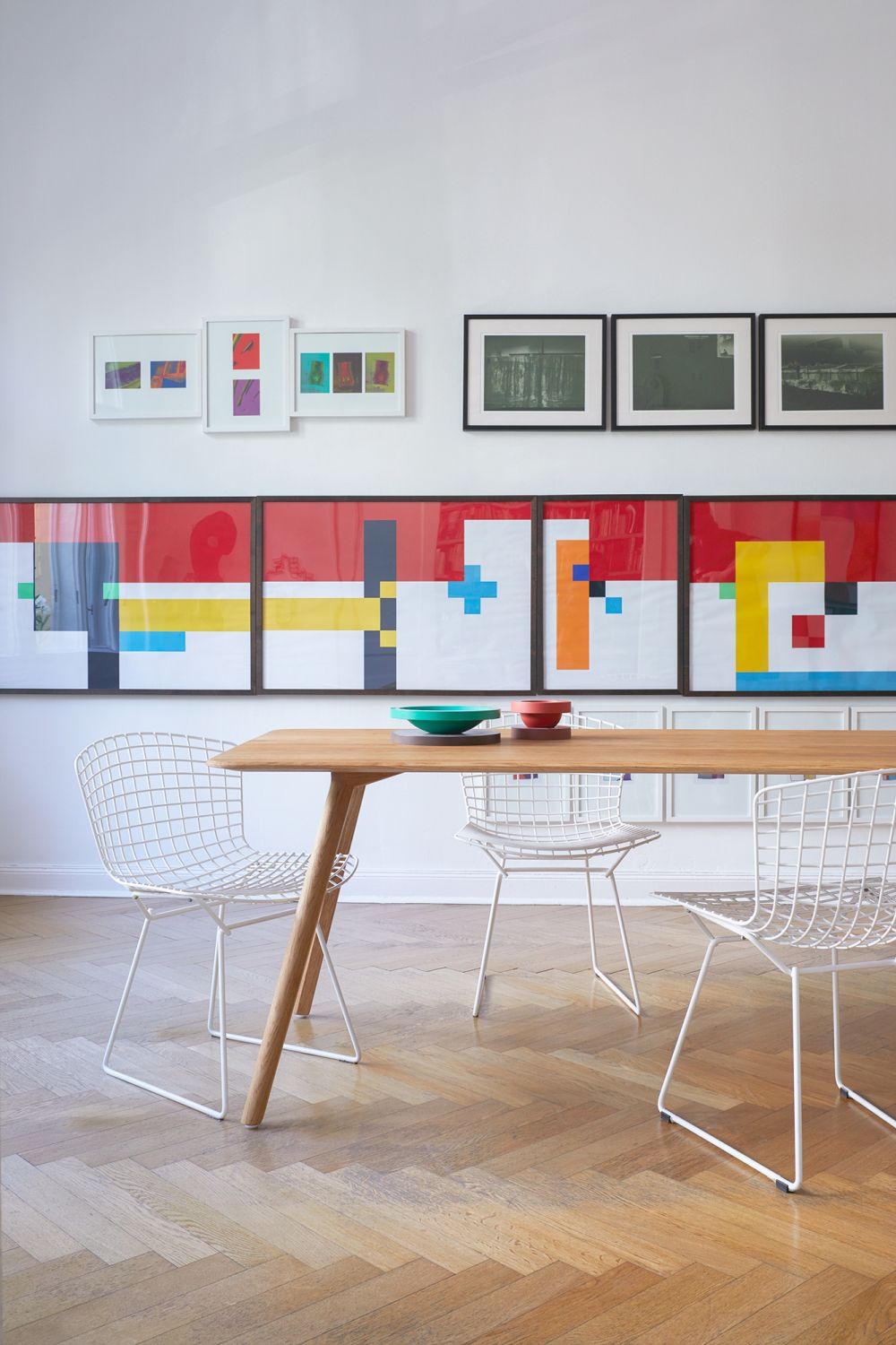 MEYER Tisch Large OUT Esstisch aus Eiche mit Stühlen und Kunst an der Wand.