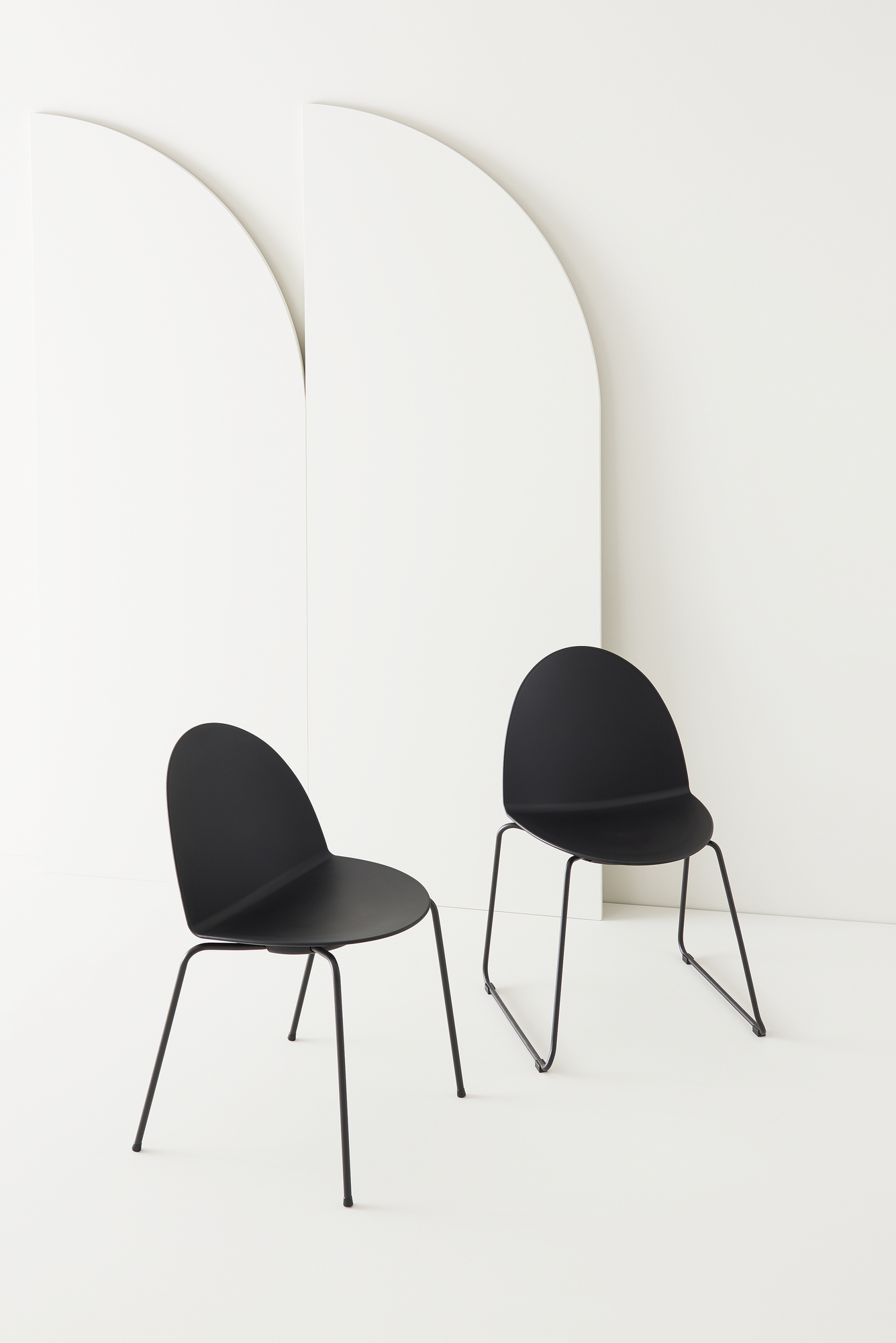 Zwei schwarze Stühle mit Kufengestell, minimalistisches Design für Esszimmer oder Büro.