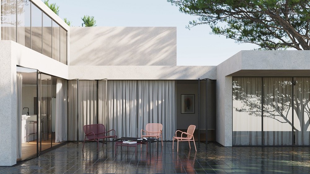 Week-End Garden Armchair Sessel Petite Friture Blush auf einer Terrasse mit Gartenmöbeln und minimalistischer Architektur.