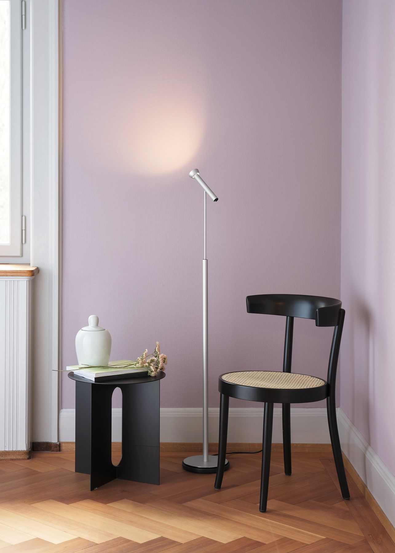 TOPOLED S Stehleuchte von Baltensweiler im modernen Wohnzimmer mit Beistelltisch und Stuhl.