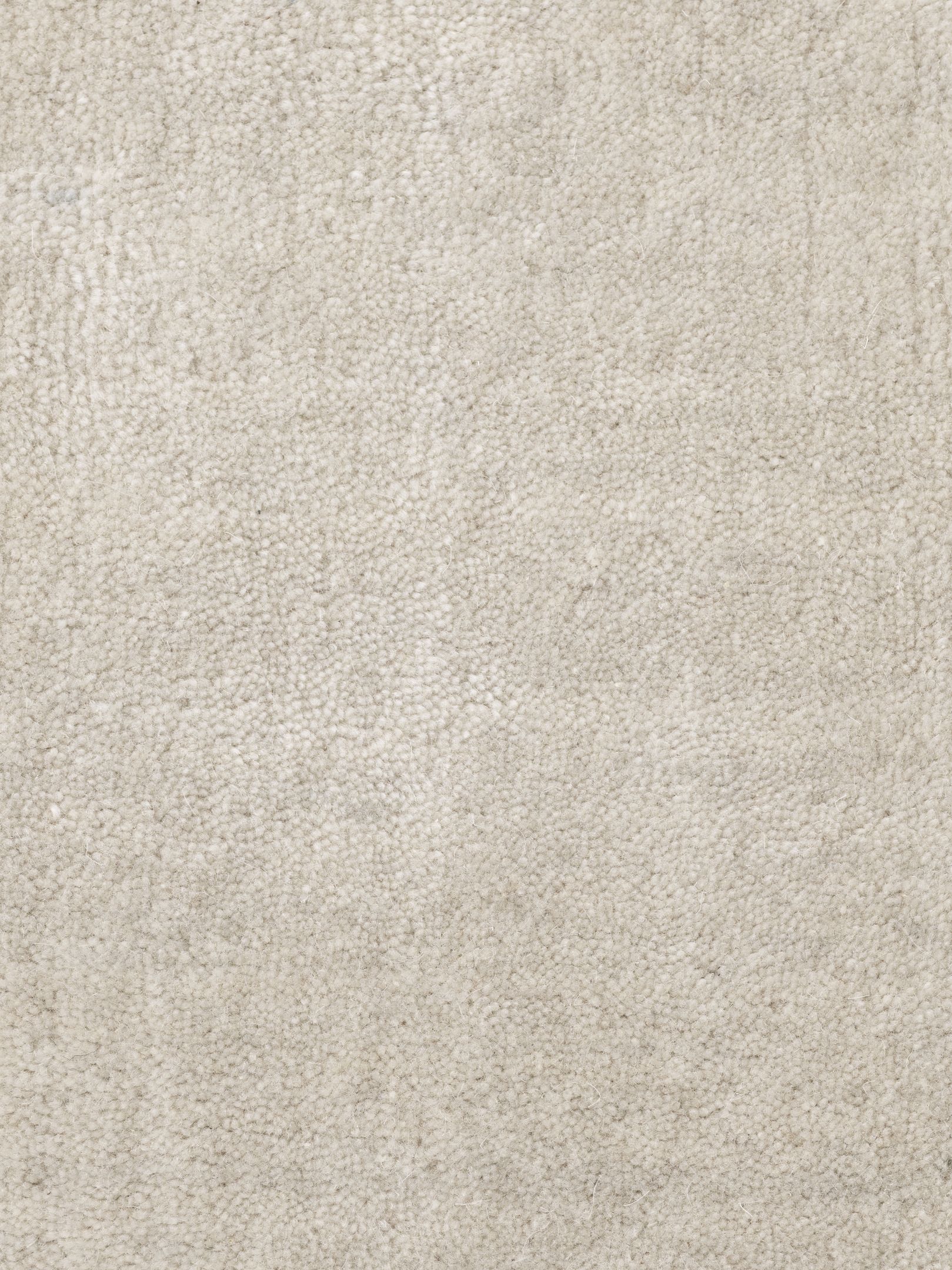 Detailaufnahme des Vipp Wollteppichs in Beige, ein luxuriöser, handgefertigter Teppich aus Wolle und Bambus.