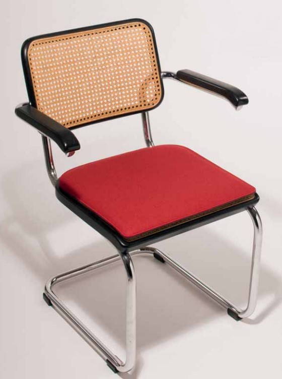 Bild eines Freischwinger-Stuhls Thonet S32 mit roter Sitzauflage und Wiener Geflecht im Rücken.