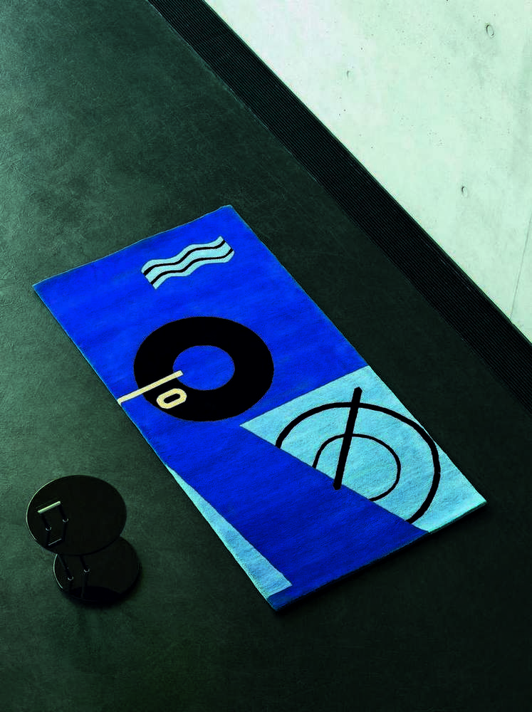 Blauer Teppich mit abstrakten Mustern und ClassiCon Occasional Table Beistelltisch im Hintergrund.