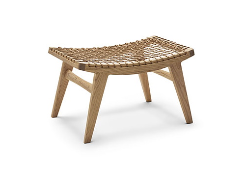 Klismos Hocker von Knoll International: Holz Hocker mit geflochtener Sitzfläche und Filzgleitern.