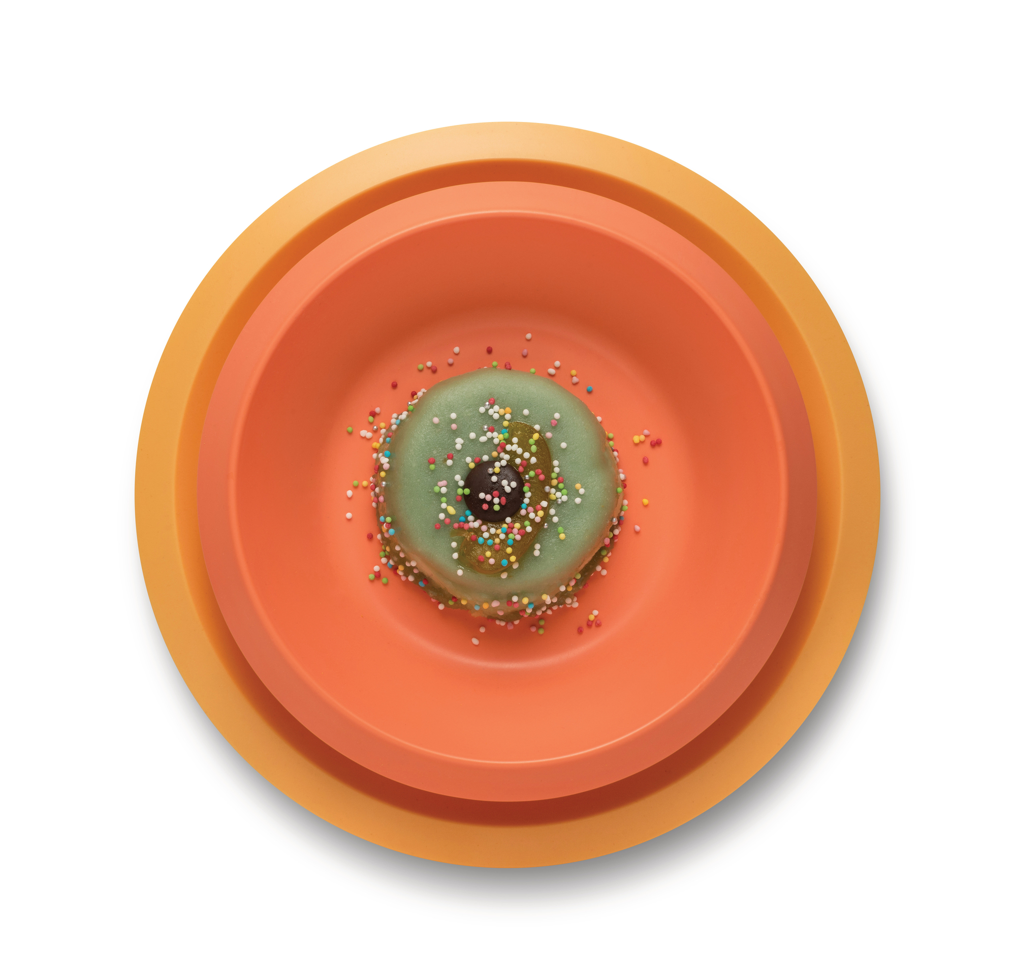 Alessi Kindergeschirr Giro Kids Collection: Teller-Set in Orange- und Gelbtönen mit Donut.