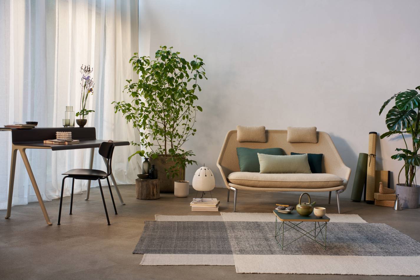 Beige Slow Sofa von Vitra mit Stoffbezug und grünen Kissen in modernem Wohnzimmerambiente.