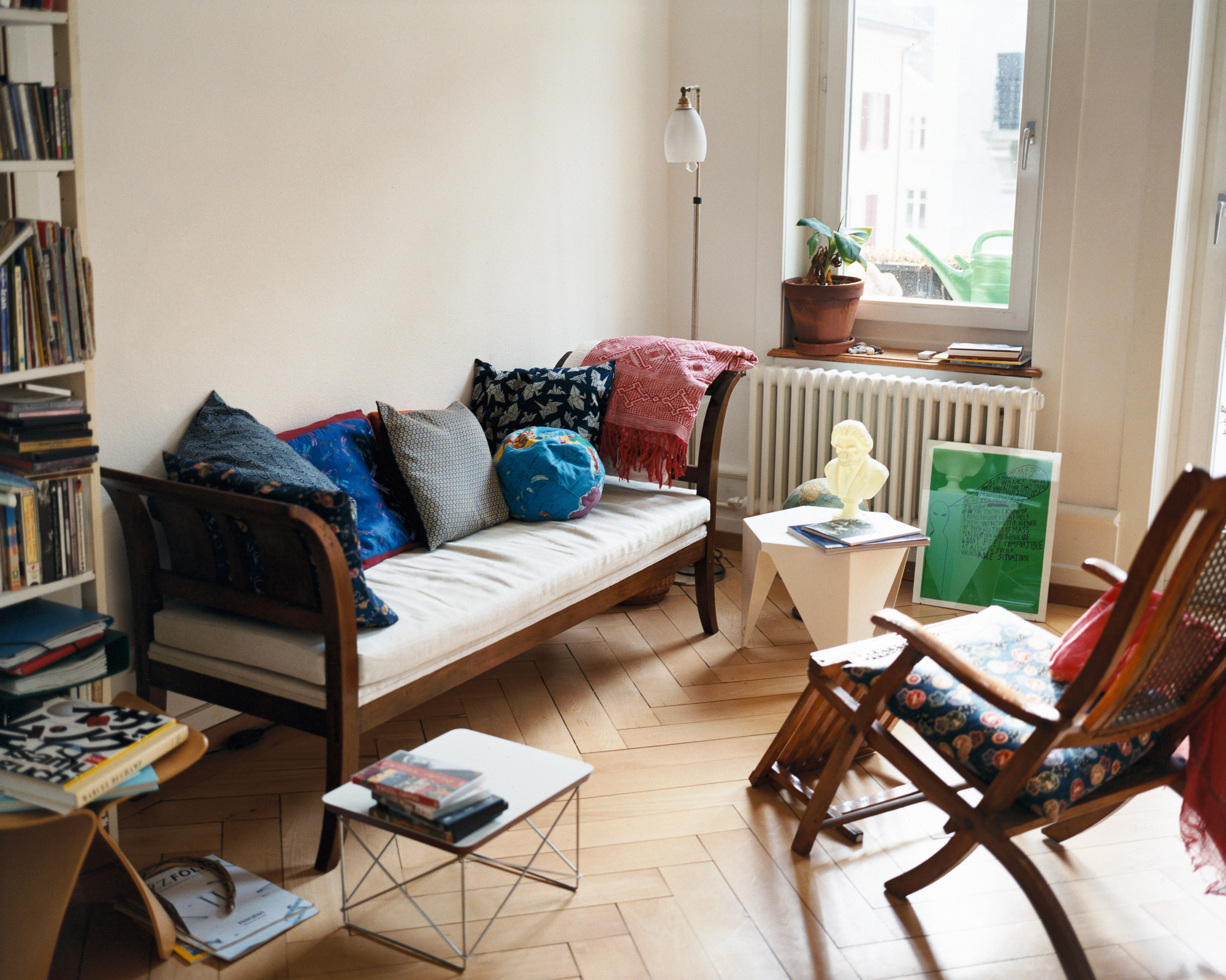 Wohnzimmer mit Vitra LTR Beistelltisch, weißem HPL, neben Sofa und Sessel. Designmöbel für Wohnraum.