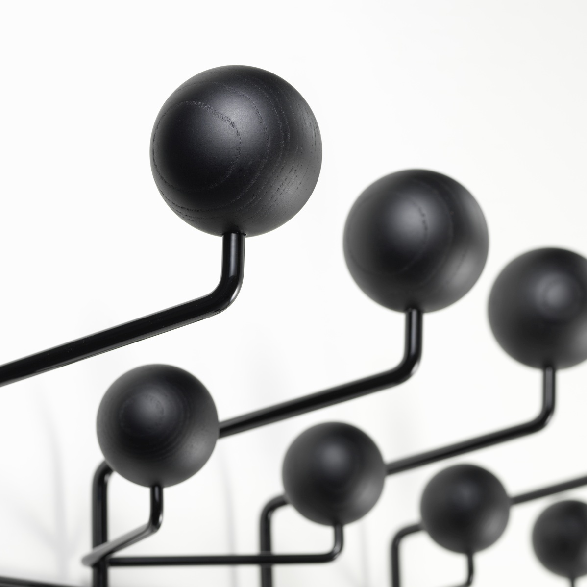 Detailaufnahme der Eames Hang it all Garderobe von Vitra in Esche schwarz, moderne Wandgarderobe.
