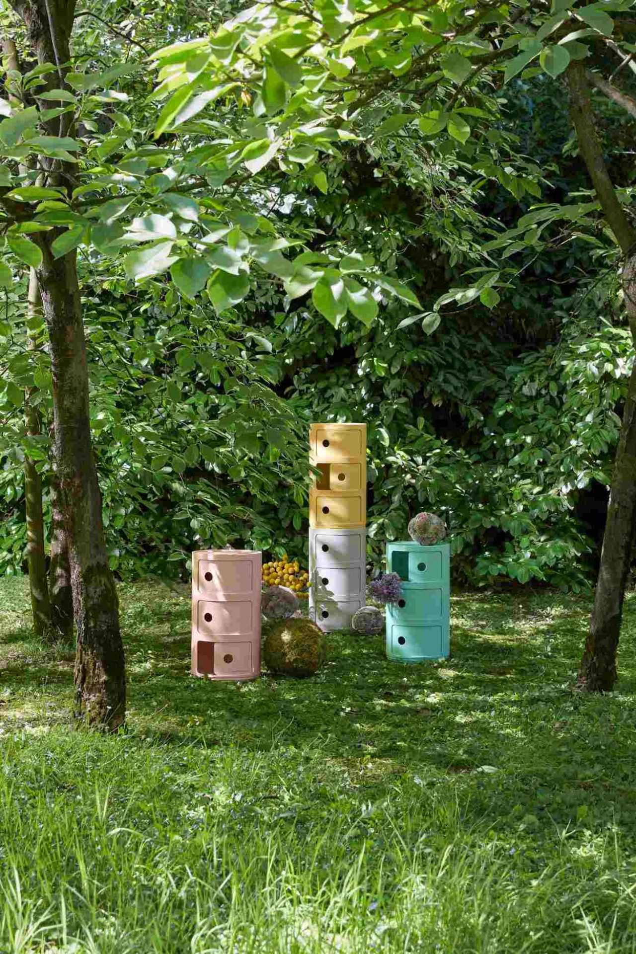 Componibili BIO 3er Element Kartell in Creme, gelb, rosa und türkis im Garten. Aufbewahrungsmöbel.