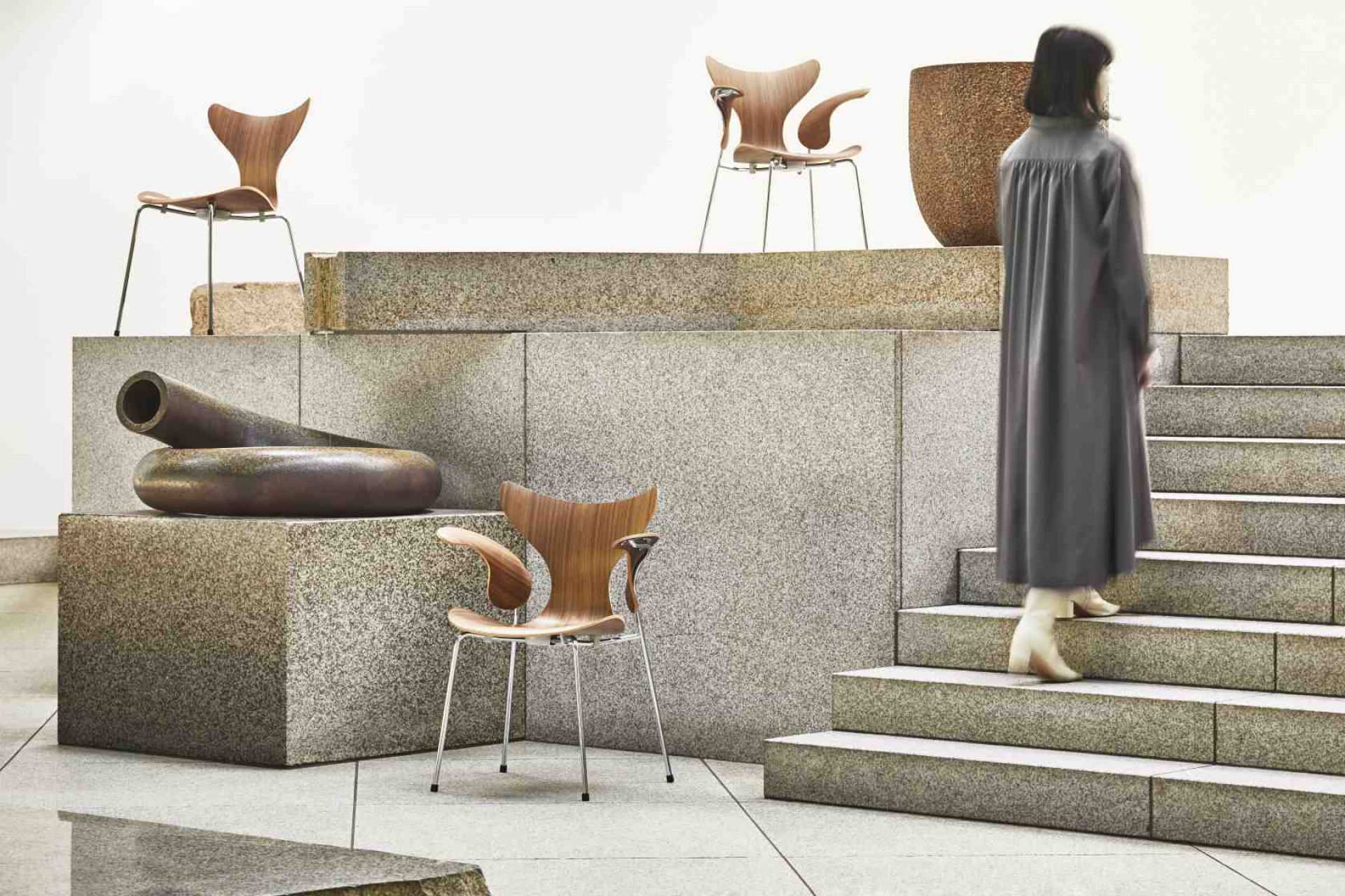 Fritz Hansen Lily Stuhl 3208 aus Holz mit Armlehne und verchromten Beinen in modernem Ambiente.
