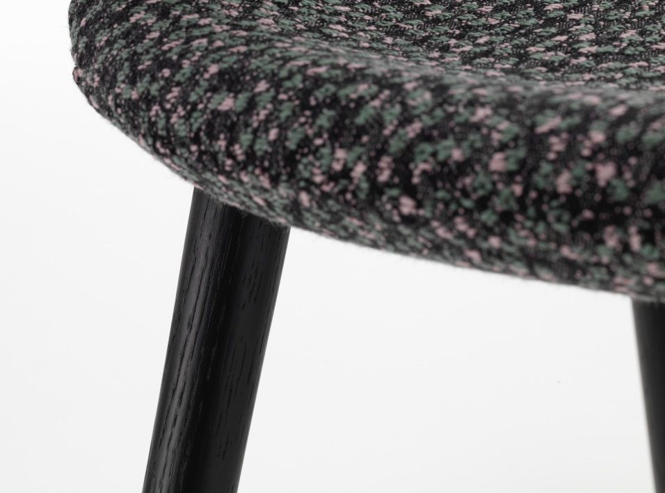 Detailaufnahme Organic Conference Stuhl von Vitra mit Kvadrat Ria Stoff und schwarzen Holzbeinen.