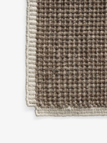 Detailaufnahme des AndTradition Collect Rug SC84 Teppichs in Braun mit heller Bordüre, gewebte Textur.