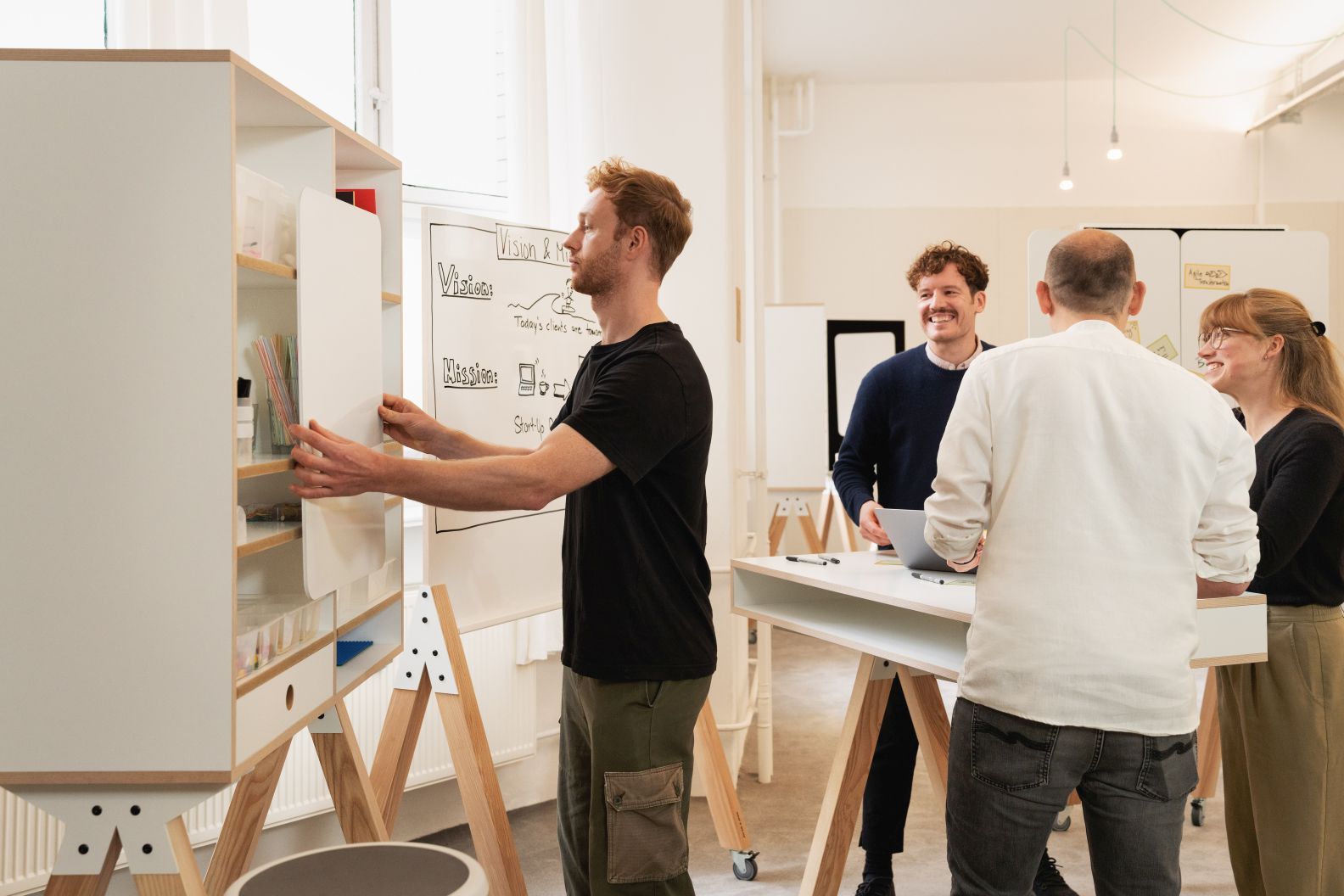 What if We Fly Taskboard: Büro-Team nutzt Interstuhl Medienwand für Brainstorming und kreative Zusammenarbeit.
