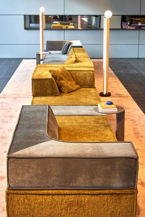 Nahaufnahme des modularen Trio Sofas in Senfgelb und Grau mit Eckanordnung, modernes Wohnzimmerdesign.