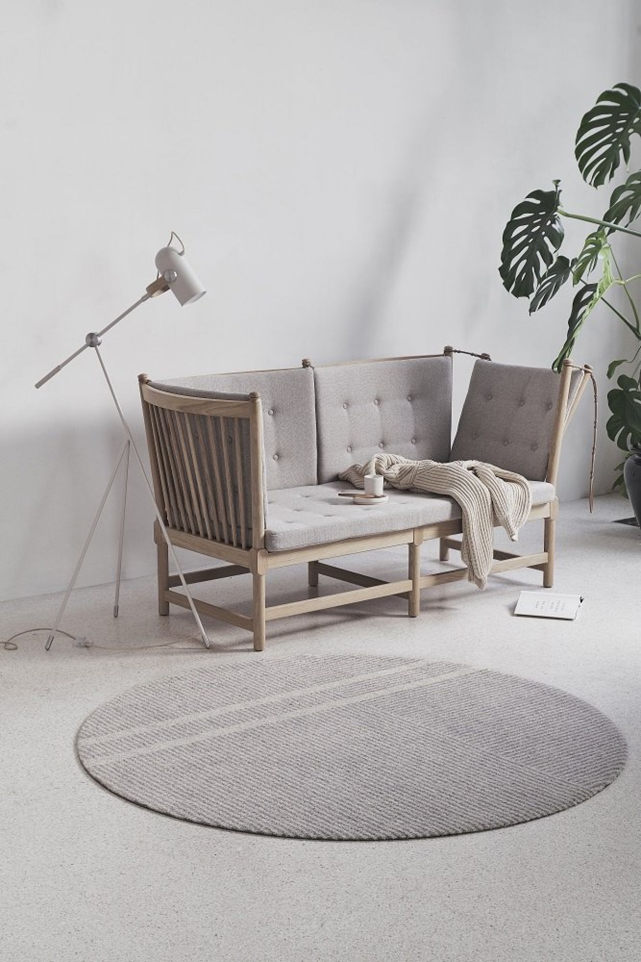 Løype Fußmatte in Breezy Beige vor hellem Sofa und Zimmerpflanze, stilvolle Indoor und Outdoor Fußmatte.