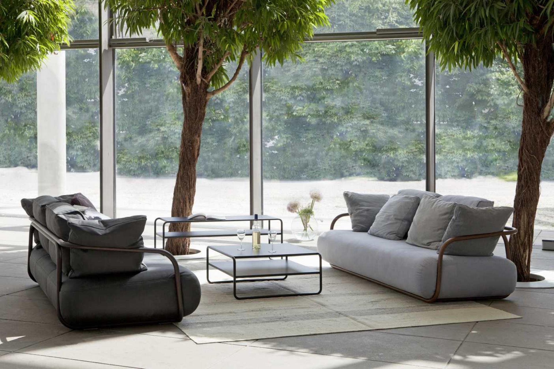 B 10/1 Thonet Beistelltisch aus Stahlrohr im modernen Wohnzimmer mit Sofa und großem Fenster.