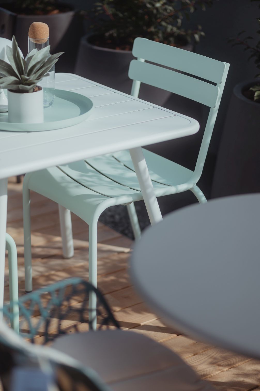 Heller Luxembourg Outdoor Tisch mit Vierfußgestell und passendem Stuhl auf einer Terrasse.